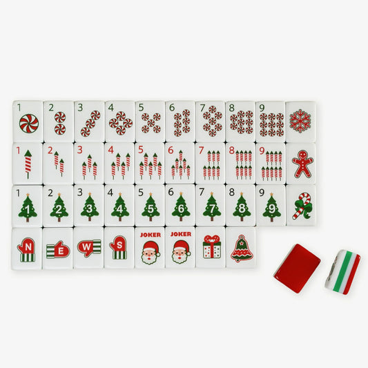 Set of Christmas-themed dominoes with various symbols on a white background