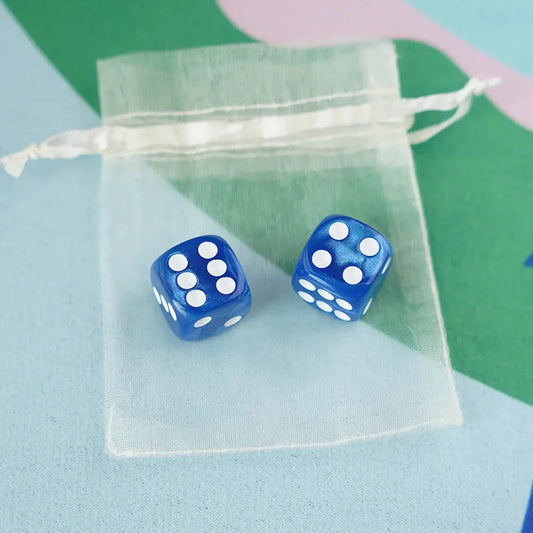 pair of cornflower blue 5/8 inch marbled acrylic mahjong dice with white pips in a sheer organza pouch.